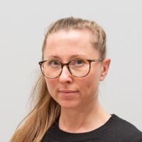 Miriam Göbel - Sales Development Representative: Woman with long blonde hair in a braid and round horn-rimmed glasses.