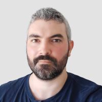 Branislav Lovrenski - Developer: Man with short, grey, frizzy hair and a full black-grey beard.