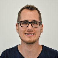 Dr Benedikt Brief - Chief Data Officer: Smiling man with brown short hair; light brown short beard and angular thick black glasses.