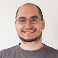 Markus Seiffert - Senior Developer: Smiling man with black beard; blue eyes and square, silver glasses.